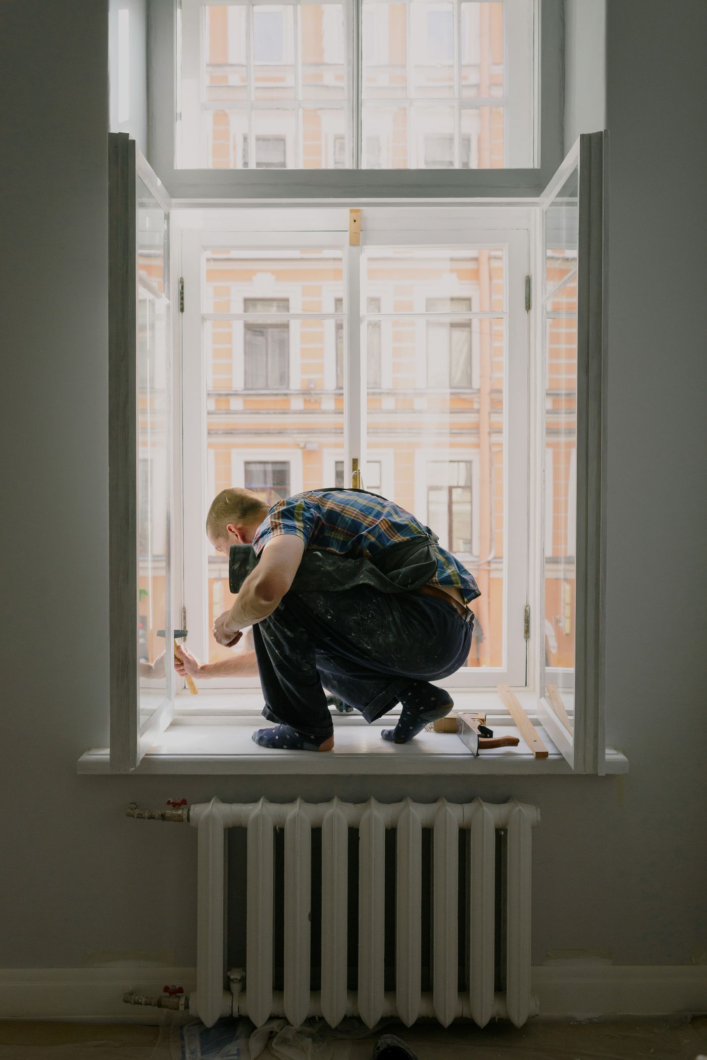 Craftsperson carefully working on a window frame